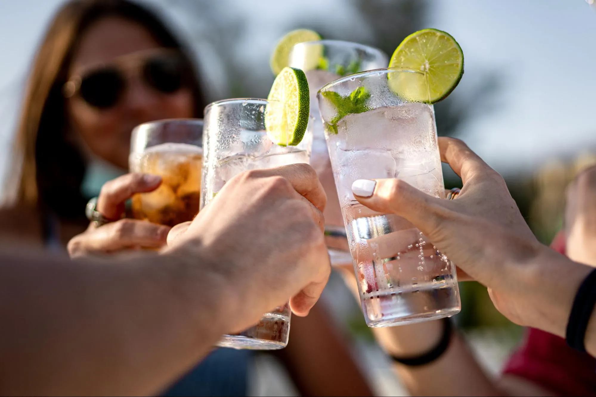 group of friends at one of the logan circle restaurants cheering a mixed drinks
