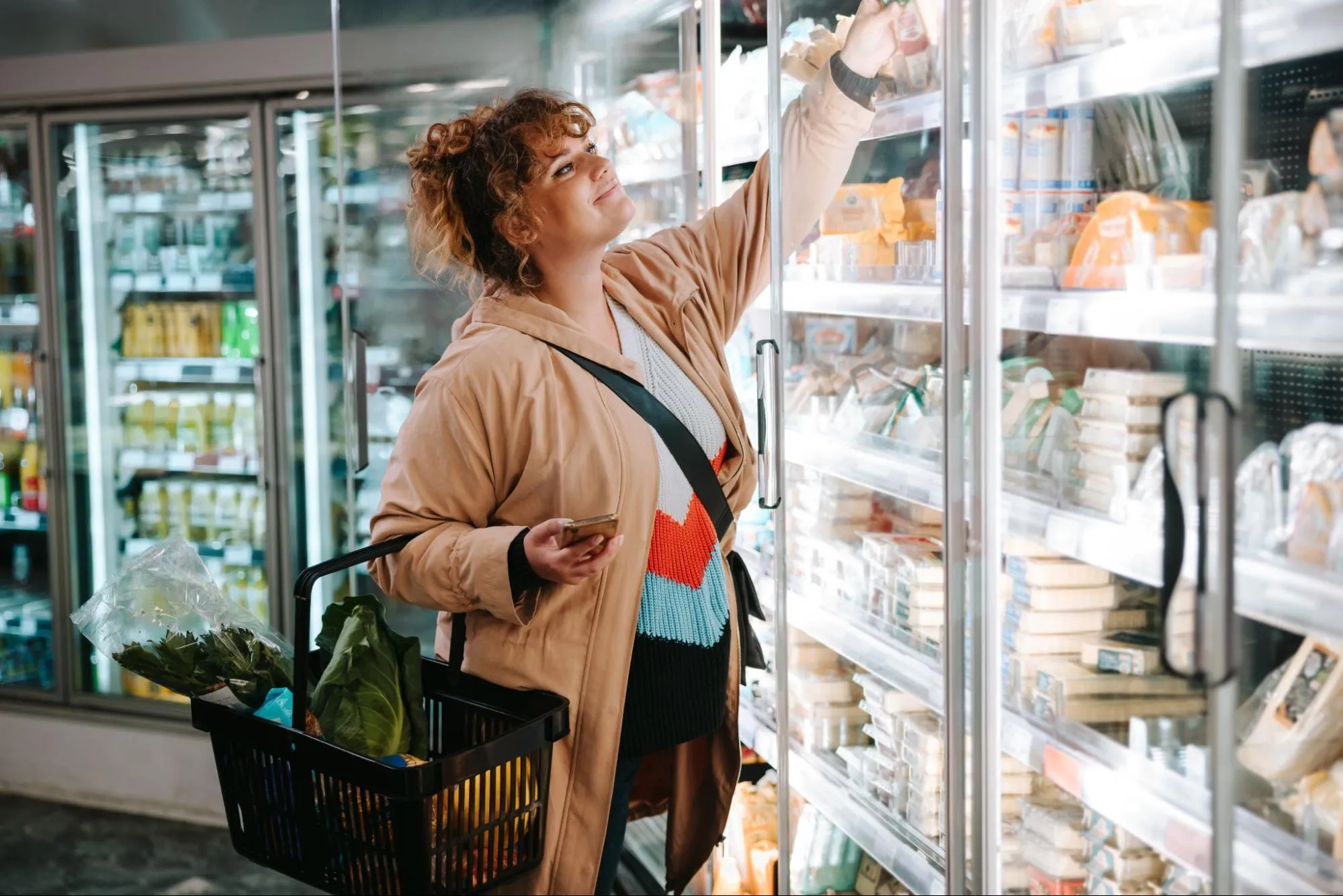 A woman selecting fresh produce at a grocery store near Dupont Circle
