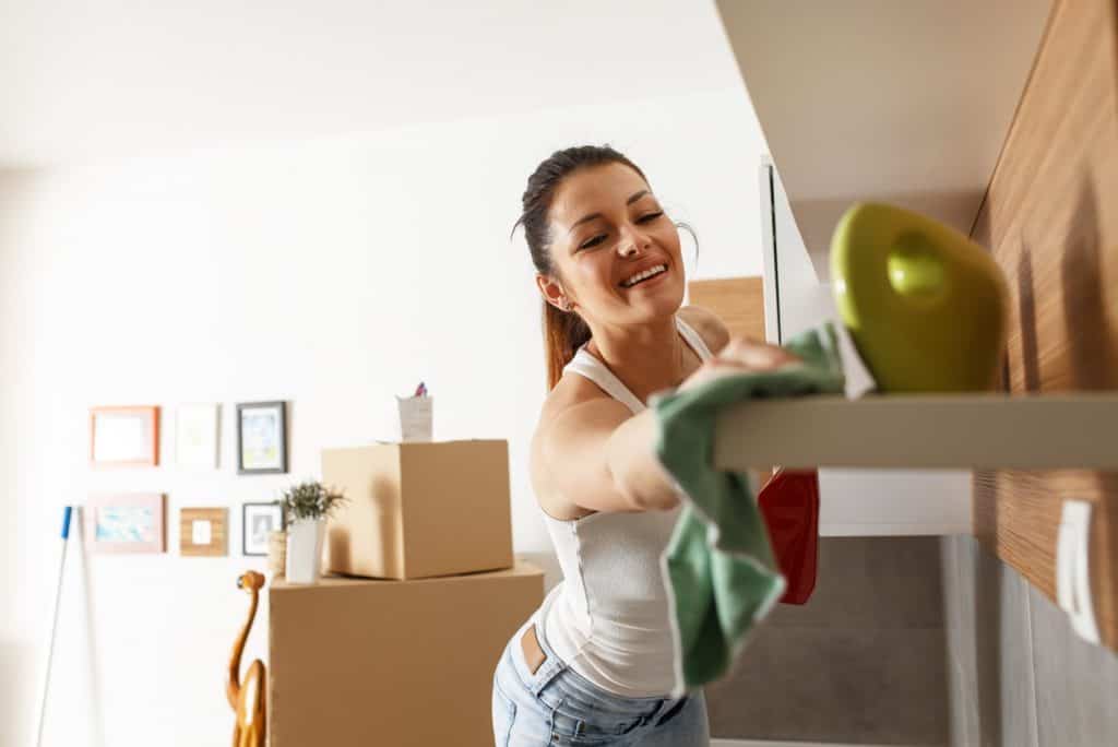 woman cleaning the shelf